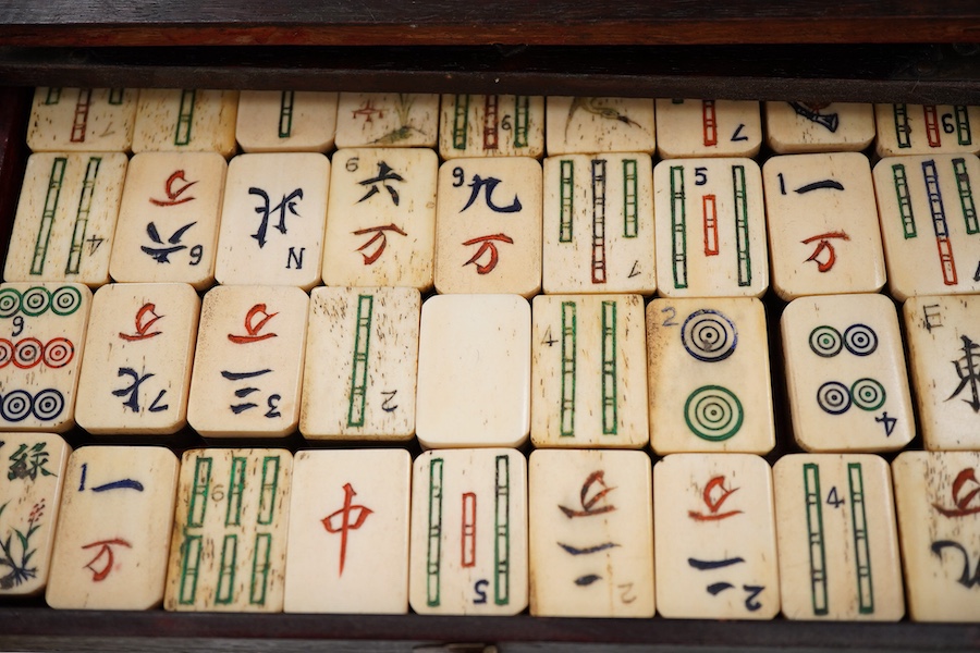 A Chinese bone and bamboo Mah-Jong set, 24cm wide